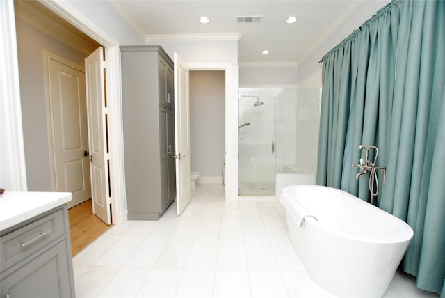 full bathroom with shower with separate bathtub, vanity, tile patterned flooring, crown molding, and toilet