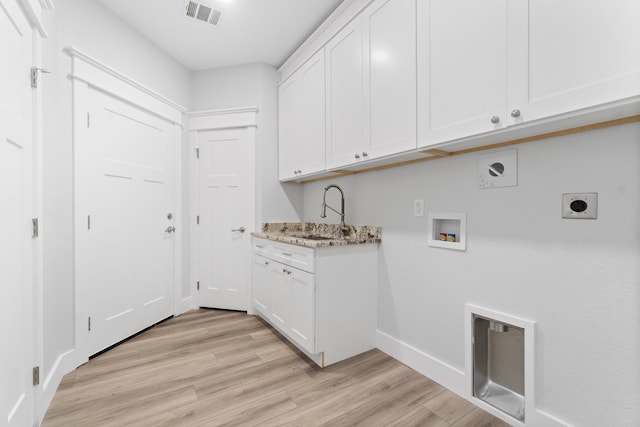 laundry room featuring light hardwood / wood-style flooring, cabinets, sink, and electric dryer hookup