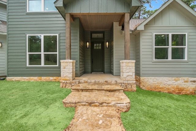 entrance to property with a lawn