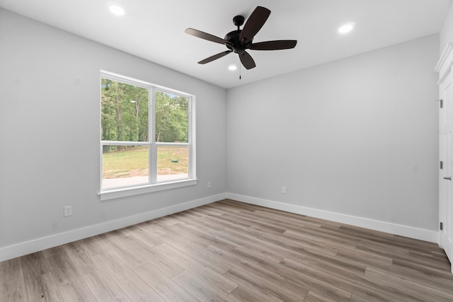 empty room with ceiling fan and light wood-type flooring