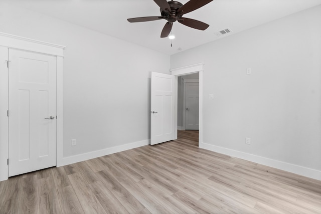 spare room with ceiling fan and light wood-type flooring