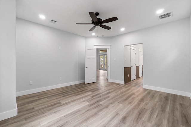 empty room featuring ceiling fan and light hardwood / wood-style flooring