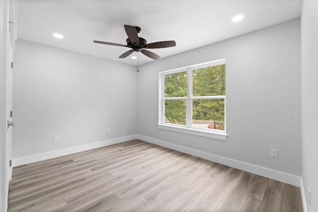 spare room featuring ceiling fan and light hardwood / wood-style floors