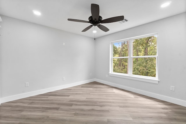 spare room featuring light hardwood / wood-style flooring and ceiling fan