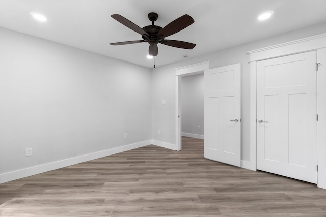 unfurnished bedroom featuring ceiling fan and light wood-type flooring