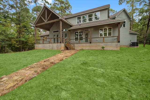 back of house featuring a yard and central AC unit