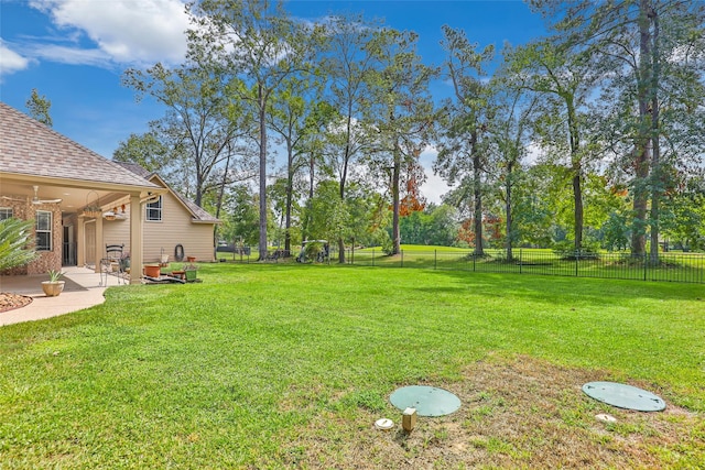 view of yard featuring a patio and ceiling fan