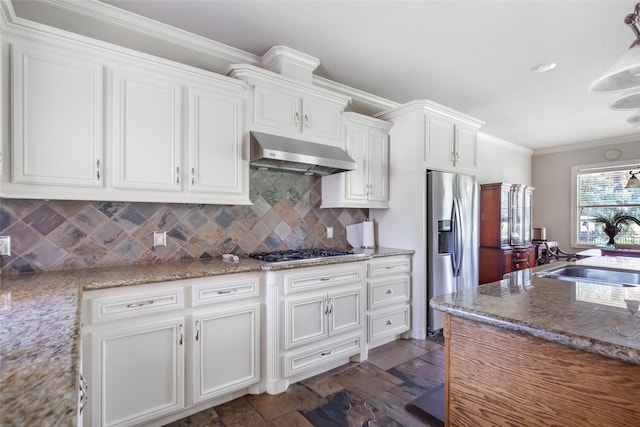 kitchen with white cabinetry, sink, stainless steel appliances, tasteful backsplash, and extractor fan