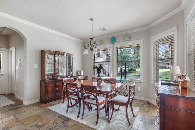 dining space with crown molding and a notable chandelier