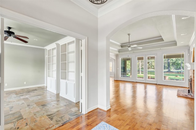 unfurnished room with ceiling fan, ornamental molding, and a tray ceiling