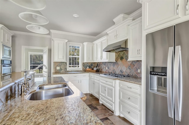 kitchen featuring tasteful backsplash, white cabinetry, sink, and stainless steel appliances