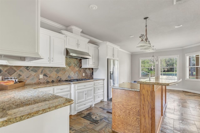 kitchen featuring a center island, ventilation hood, backsplash, white cabinets, and appliances with stainless steel finishes