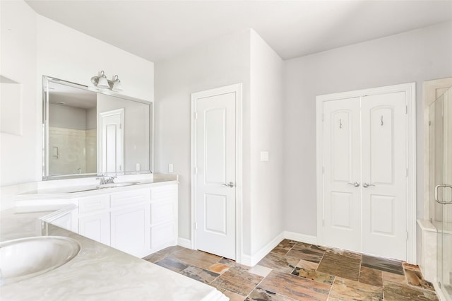 bathroom featuring vanity and a shower with shower door