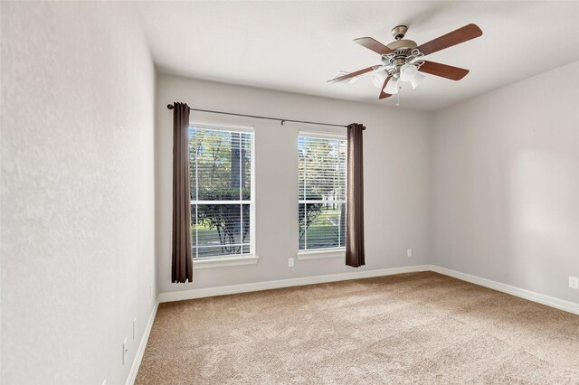 carpeted spare room with ceiling fan