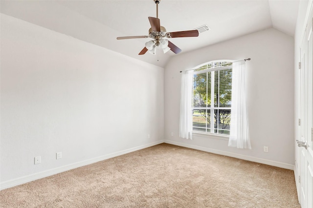 unfurnished room featuring light colored carpet, vaulted ceiling, and ceiling fan