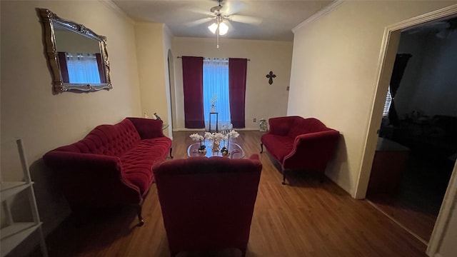 living room featuring crown molding, ceiling fan, and wood-type flooring