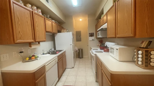 kitchen featuring white appliances, electric panel, light tile patterned flooring, and sink