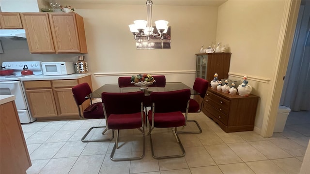 dining space featuring a notable chandelier and light tile patterned floors