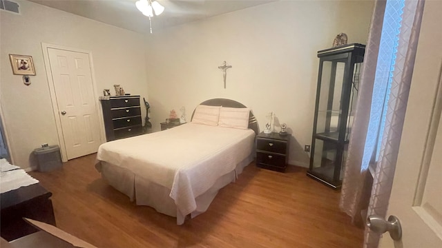 bedroom with wood-type flooring and ceiling fan