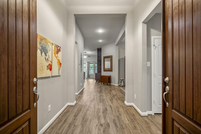 entrance foyer featuring light wood-type flooring and baseboards