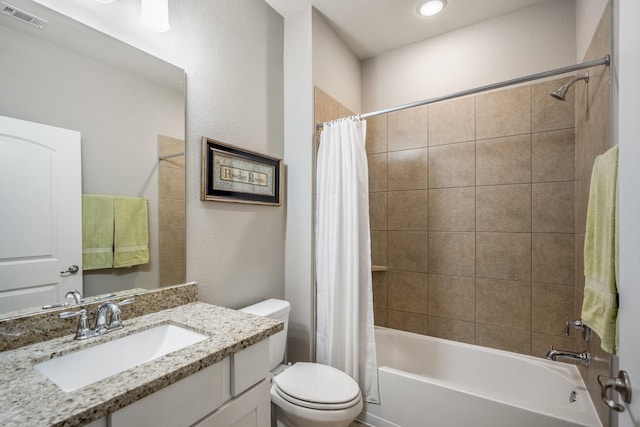 full bath with toilet, visible vents, shower / bath combo with shower curtain, and vanity