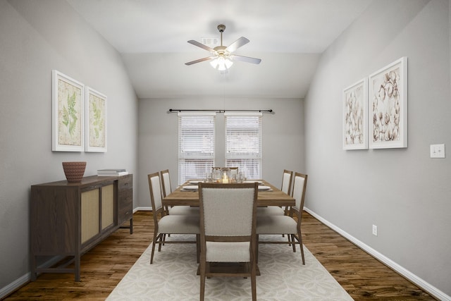 dining room with ceiling fan, baseboards, vaulted ceiling, and wood finished floors