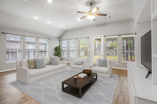 living area featuring visible vents, ceiling fan, baseboards, and wood finished floors