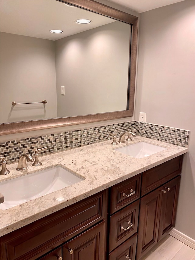 bathroom with vanity and tasteful backsplash