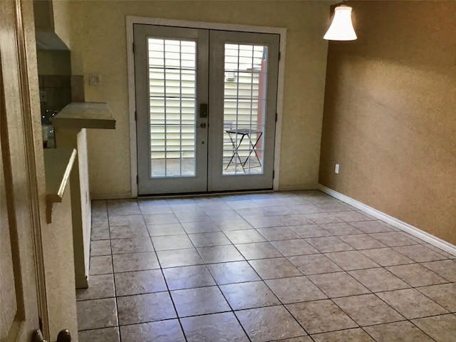 entryway with french doors and light tile patterned flooring