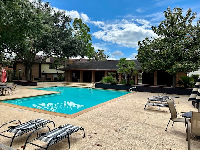 view of swimming pool with a patio