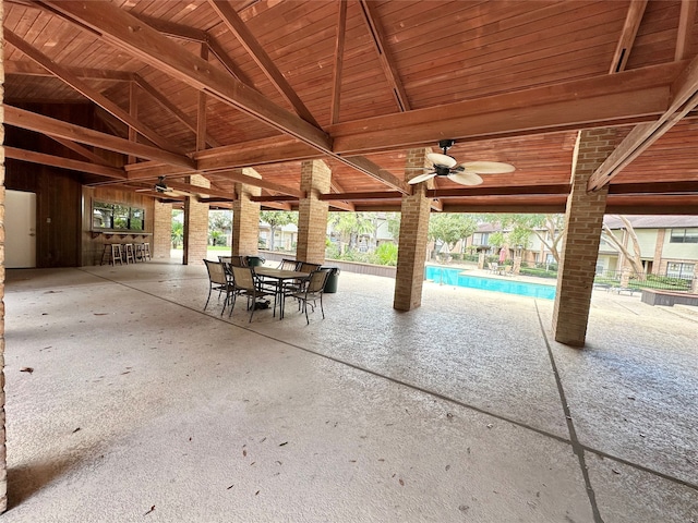 view of patio with an indoor pool and ceiling fan