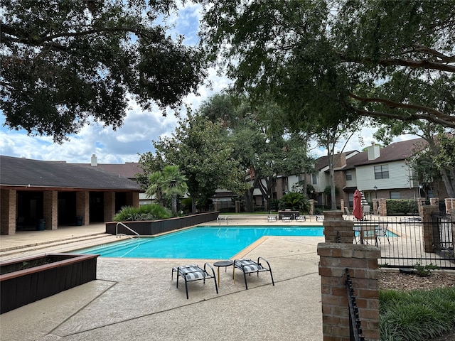 view of swimming pool with a patio area