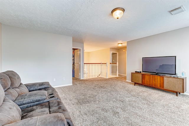 living room with a textured ceiling and carpet floors