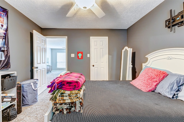 carpeted bedroom featuring a textured ceiling and ceiling fan