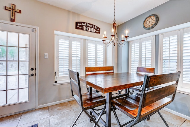 tiled dining space with an inviting chandelier