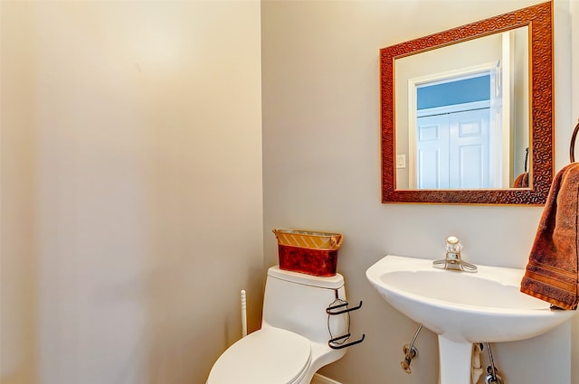 bathroom featuring toilet and sink