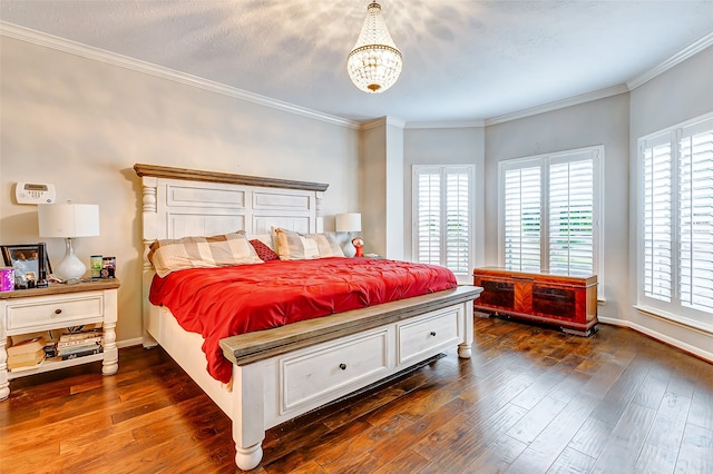 bedroom with dark hardwood / wood-style floors, an inviting chandelier, and ornamental molding