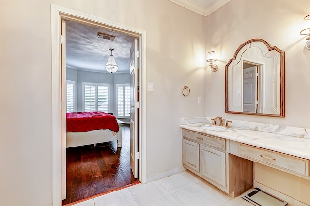 bathroom featuring ornamental molding, vanity, and hardwood / wood-style floors