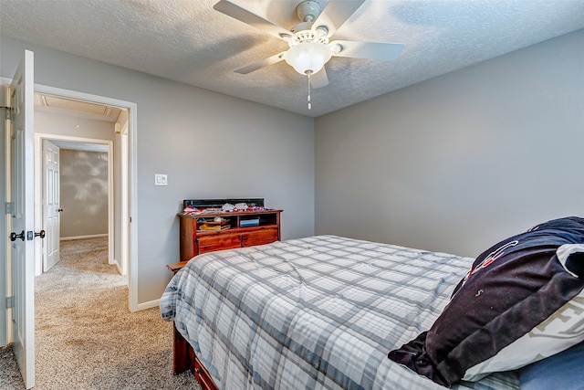 bedroom with a textured ceiling, ceiling fan, and carpet floors