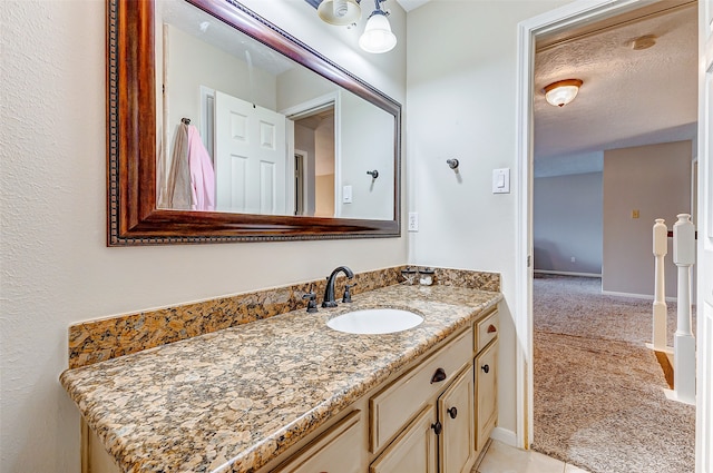 bathroom with vanity and a textured ceiling