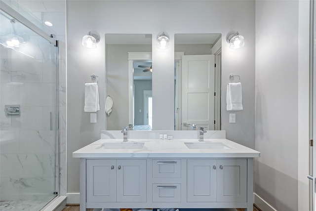 bathroom featuring walk in shower, ceiling fan, and vanity