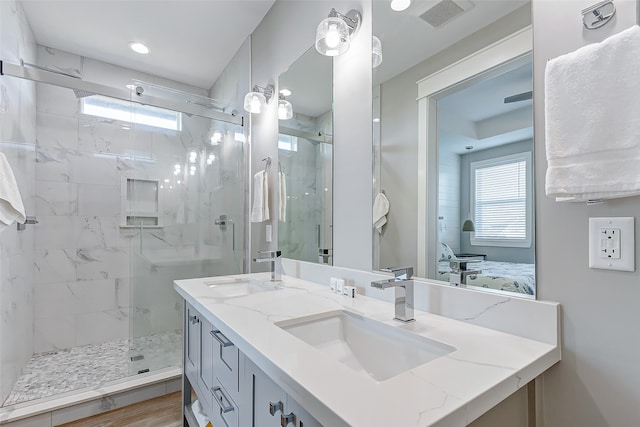 bathroom with walk in shower and vanity