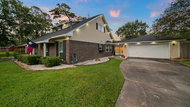 view of front of home featuring a lawn and a garage