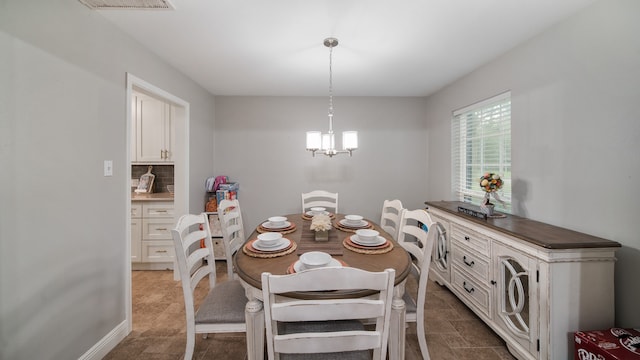 dining space with an inviting chandelier