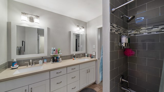 bathroom featuring vanity and tiled shower