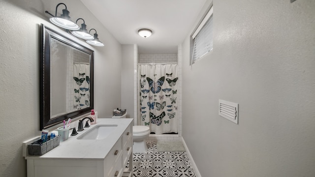 bathroom featuring tile patterned flooring, a shower with curtain, vanity, and toilet