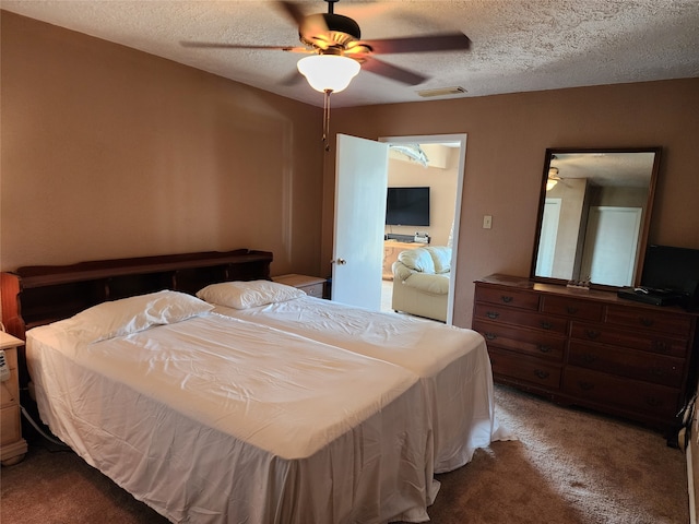 bedroom with a textured ceiling, ceiling fan, and carpet floors