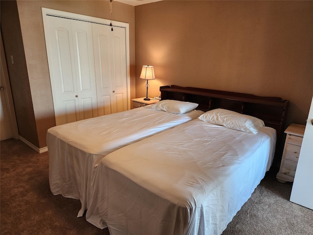 bedroom featuring dark carpet and a closet