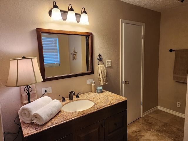 bathroom with vanity and a textured ceiling