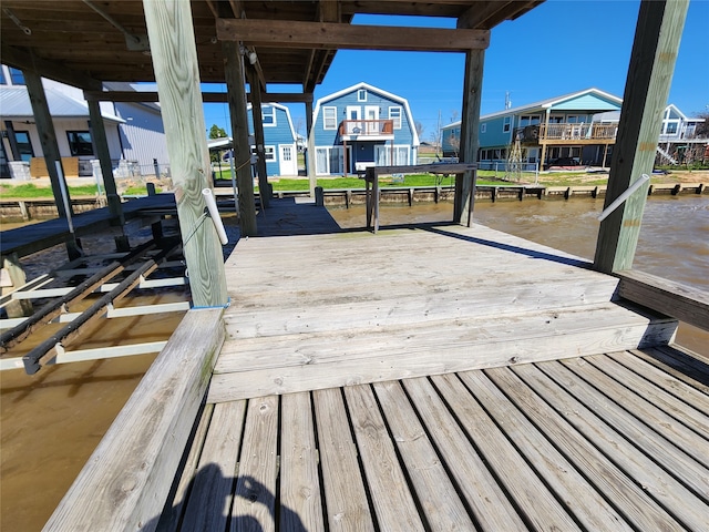 dock area featuring a water view and a residential view